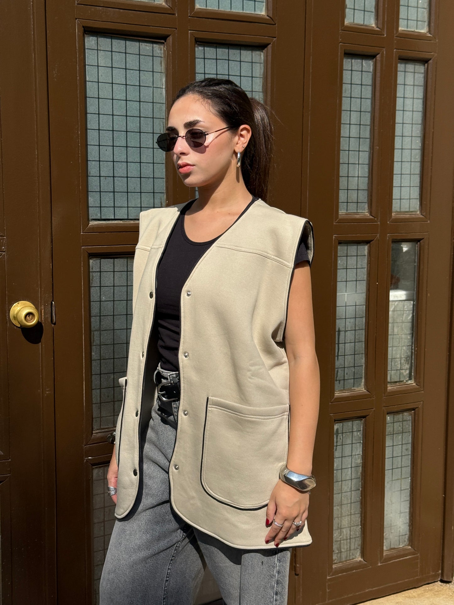 Beige vest with black trim