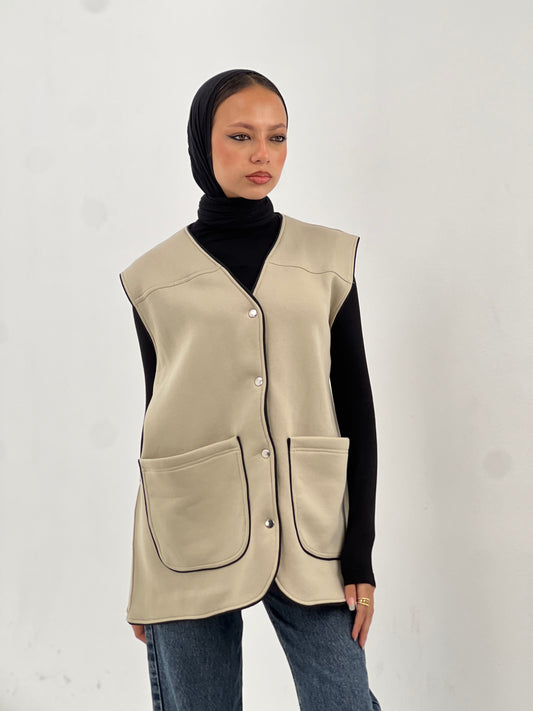 Beige vest with black trim